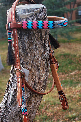 A horse wearing a custom beaded headstall from The Brown Cow Saddle Blanket Company.